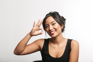 Poster - Pretty young asian woman sitting at the table