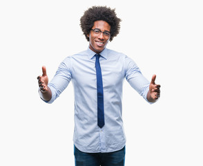 Poster - Afro american business man wearing glasses over isolated background looking at the camera smiling with open arms for hug. Cheerful expression embracing happiness.