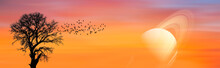 A Silhouette Of Large Bird Flock With Lone Dead Tree And Saturn Against Amazing Sunset "Elements Of This Image Furnished By NASA " 