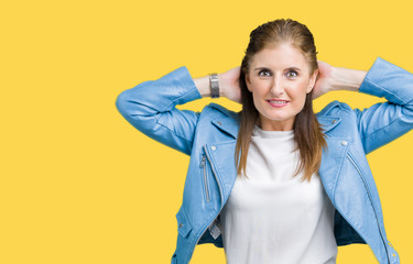 Wall Mural - Beautiful middle age mature woman wearing fashion leather jacket over isolated background Relaxing and stretching with arms and hands behind head and neck, smiling happy