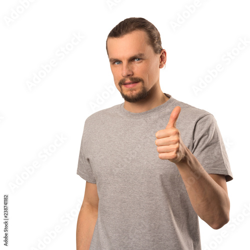 Fotografie, Obraz Bearded attractive caucasian guy holding thumb up isolated on white