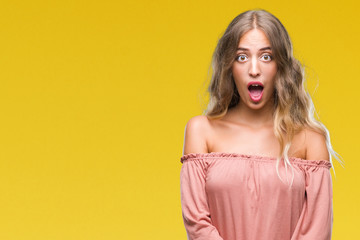 Canvas Print - Beautiful young blonde woman over isolated background afraid and shocked with surprise expression, fear and excited face.