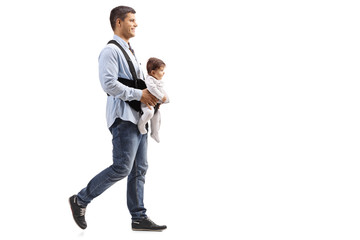 father walking with a baby in carrier