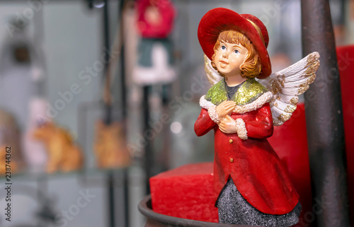 Fotografie, Obraz Vintage figurine of a girl in a red cloak with angel wings.