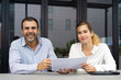 © Mangostar - Positive confident experts analyzing reports. Male and female business colleagues holding documents and smiling at camera. Expertise concept