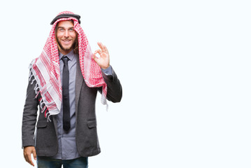 Sticker - Young handsome arabian man with long hair wearing keffiyeh over isolated background smiling positive doing ok sign with hand and fingers. Successful expression.