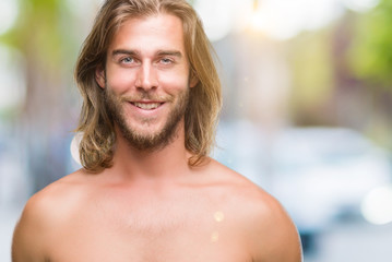 Poster - Young handsome shirtless man with long hair showing sexy body over isolated background with a happy and cool smile on face. Lucky person.