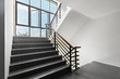 Big Stainless Window and Black Sairs in Modern Apartment, clean stairs in the building.