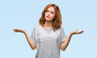 © Krakenimages.com - Young beautiful woman over isolated background clueless and confused expression with arms and hands raised. Doubt concept.