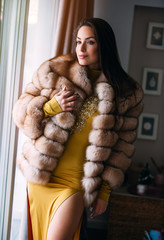 High fashion model in winter fur coat clothes