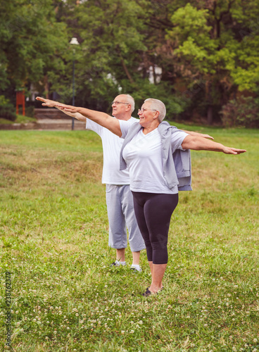 Fotografie, Obraz Senior exercise - healthy aged couple resting after sport exercises- together we workout better