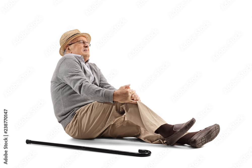 Mature man lying on the floor and holding his knee - obrazy, fototapety, plakaty 