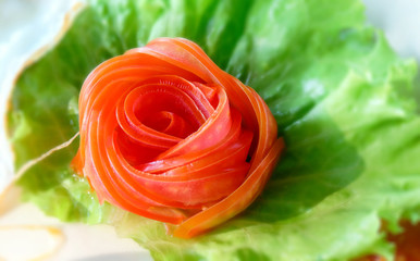 Red rose tomato vegetable carving art on dish