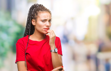 Poster - Young braided hair african american girl over isolated background looking stressed and nervous with hands on mouth biting nails. Anxiety problem.