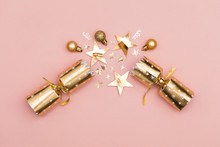 Christmas Crackers. Luxury Gold Festive Cracker On A Pastel Pink Background