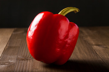 Fresh bell pepper isolated on wooden cutting board