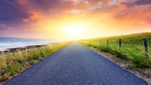 Paved Country Road . Landscape Over Clouds Sunrise . Sunset Above Road . 
