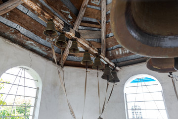 A small wooden provincial Ukrainian Orthodox Church of the Moscow Patriarchate. Church bronze bell of the Ukrainian Orthodox Church. Odessa region, Kodyma, 2012