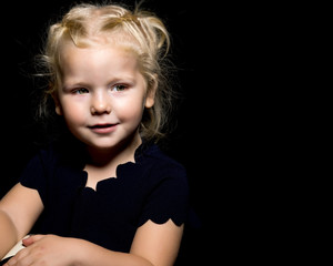 Little girl on a black background