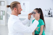 © New Africa - Children's doctor putting trial frame on little girl in clinic. Eye examination