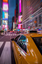 New York Yellow Cab Under Bright Lights Of Times Square