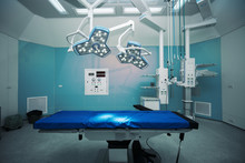 Background Of Hospital Empty Operation Room With Surgery Bed And Surgery Light