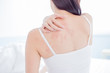woman scratching shoulder and neck