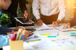 © Morakot - Business group or business partners discussing documents and ideas at meeting