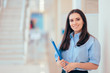 © nicoletaionescu - Professional Woman Holding Folder in Office Building