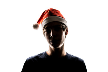 close up silhouette portrait of male teenager put on and wear new year christmas red hat isolated f