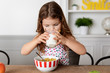 © Lisa Tichané - Little girl drinking milk at kitchen table