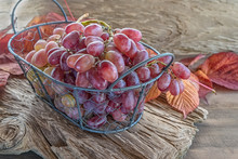 Beautiful Ripe Bunch Of Grapes On A Wooden Table In A Wicker Round Basket