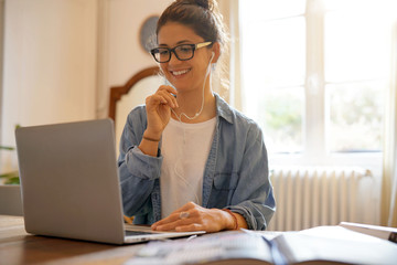 Attractive young woman working from home