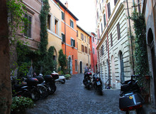 Colorful, Old, Narrow Alley In Rome With Parked Scooters