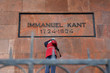A handyman in uniform on the stairs washes the grave of the philosopher Immanuel Kant after an act of vandalism. Kaliningrad, Russia