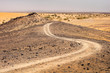 curved ground road in stone desert in Morocco