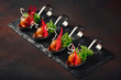 Molecular modern cuisine galantine duck in spoons on stone and rusty background