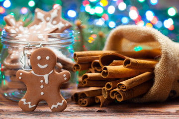 Sticker - Cinnamon sticks and gingerbread Christmas cookies on lighting background