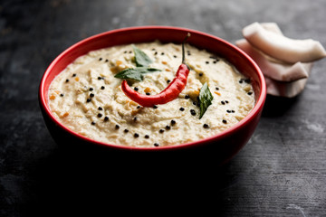 Nariyal or Coconut Chutney served in a bowl. Isolated over moody background. selective focus