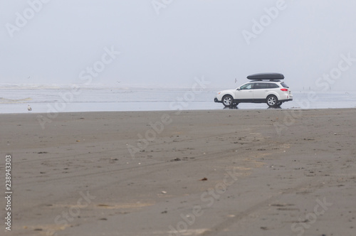 Fotografie, Obraz A white family car in Pacific beach area, Ocean Shores, WA