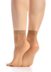 Wall Mural - Female legs in nylon socks on white background. Isolation