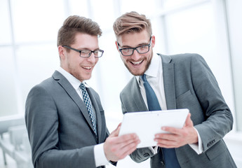 Wall Mural - two colleagues discussing information from a digital tablet