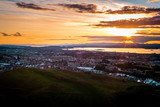 Fototapeta Las - Sunset over Edinburgh city, panoramic view and evening mood, parks and hills, illuminated sky, Scotland Great Britain