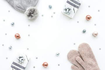 Christmas composition. Marble gift box, decorations, balls, knitted cap, mittens on white background, flat lay, top view