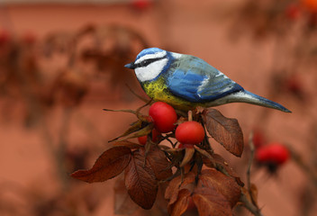 Wall Mural - wooden hand carved figures of blue tits on the nature/new year /winter background