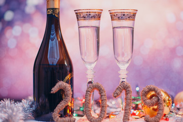 New years eve celebration background with 2019 digits  champagne and a pair of glasses with christmas decoration. Party and celebration concept.