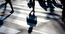 Blurry Zebra Crossing With Pedestrians Making Long Shadows