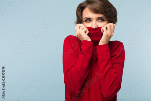 Young Thoughtful Woman With Dark Short Hair Hiding Face In Red