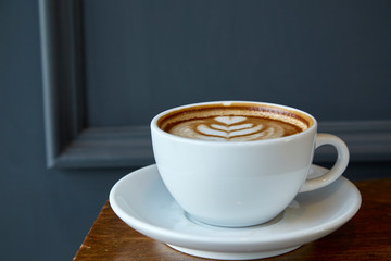 Cup of coffee with heart pattern