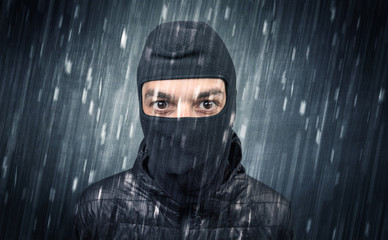 Wall Mural - Burglar in action in black clothes with rainy concept. 